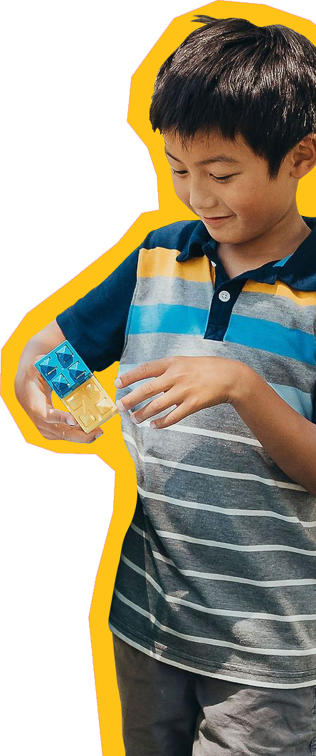 group-play-kid Child at SDCDM smiling while playing with blocks