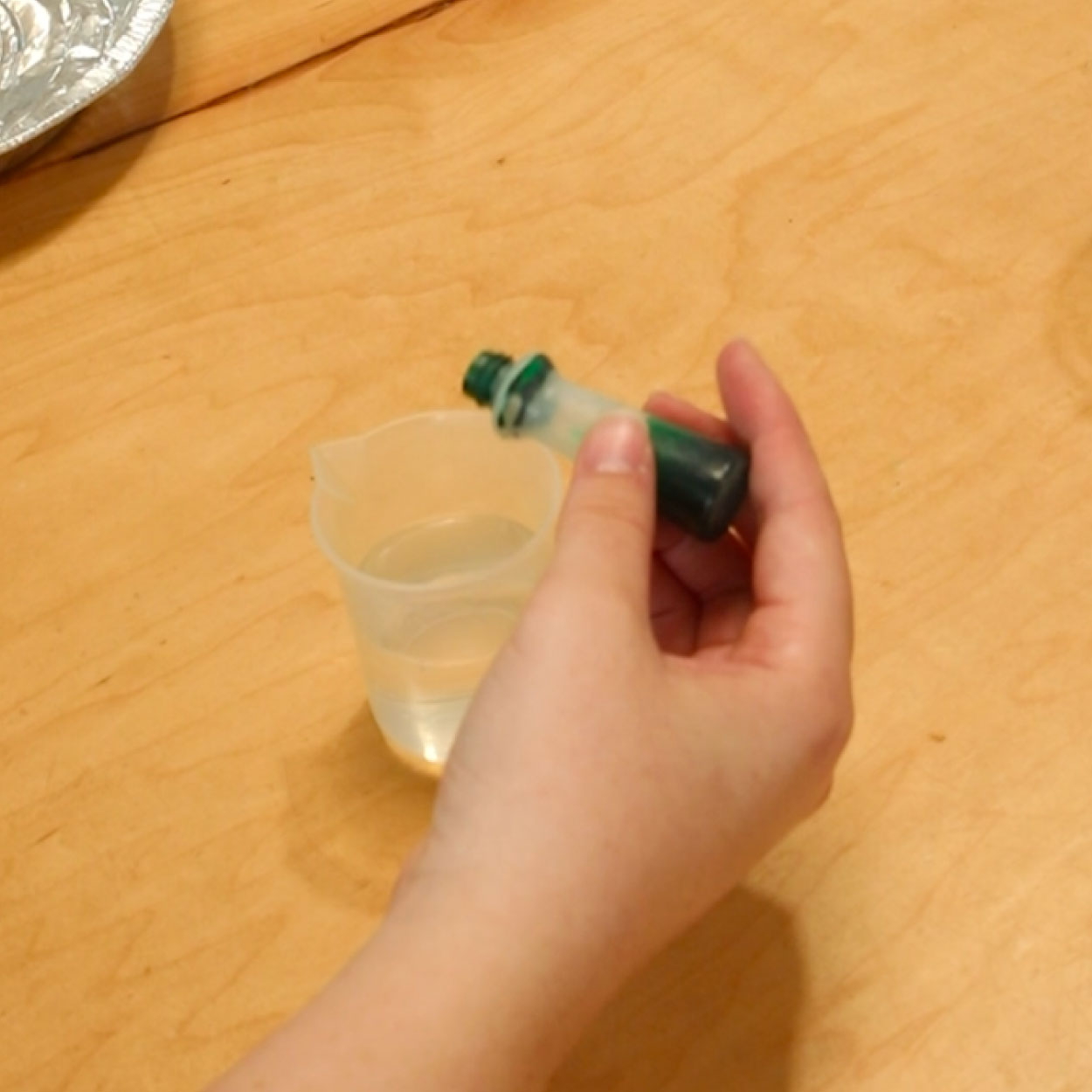 Green food coloring added to vinegar.